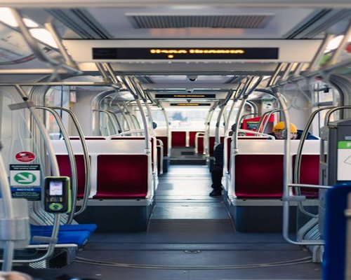 Commuters standing inside a spacious clean train